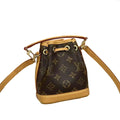 Louis Vuitton monogram canvas bucket bag with tan leather trim and strap, displayed with an orange Louis Vuitton box, shopping bag, and dust bag.